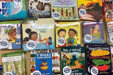 A selection of early reader books on a table.